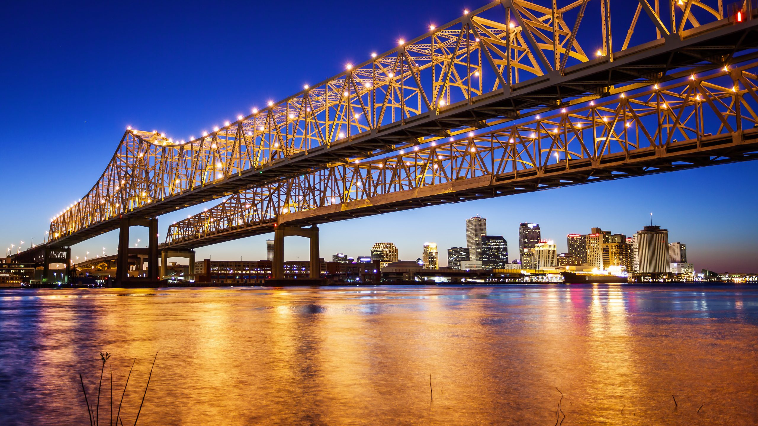 New Orleans City Skyline and Crescent City Connection Bridge at Night
